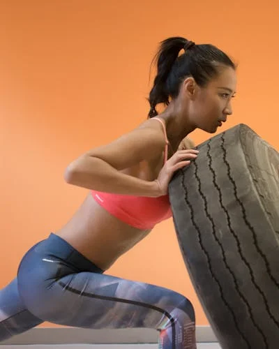 Woman fitness tire workout